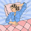 Woman in bed holding her stomach in agony